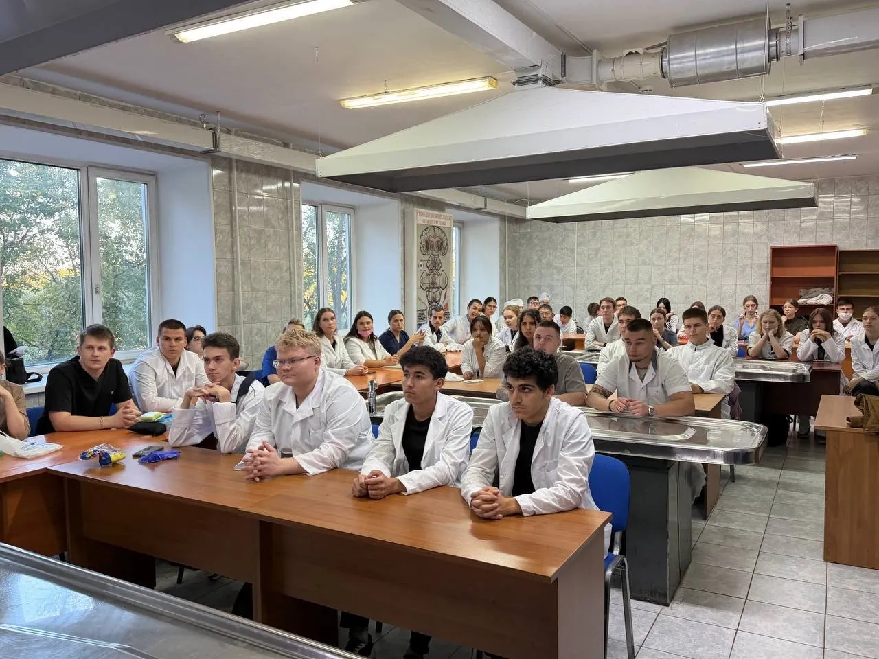Medical students learning surgical instruments and suture materials